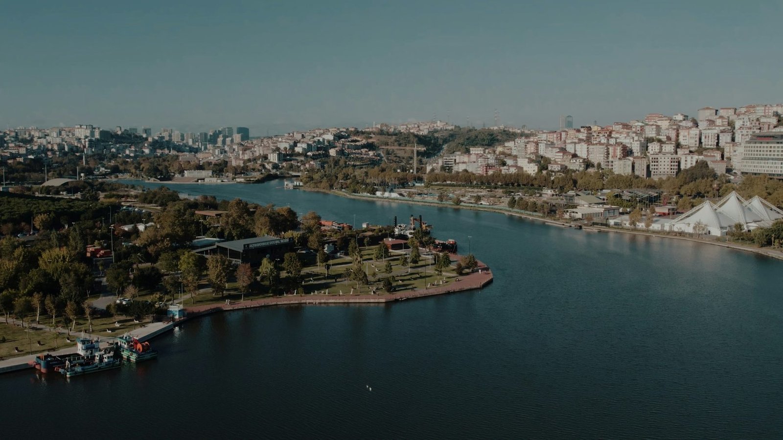 Aerial view of a riverside city where parks, water and neighbourhoods thrive together